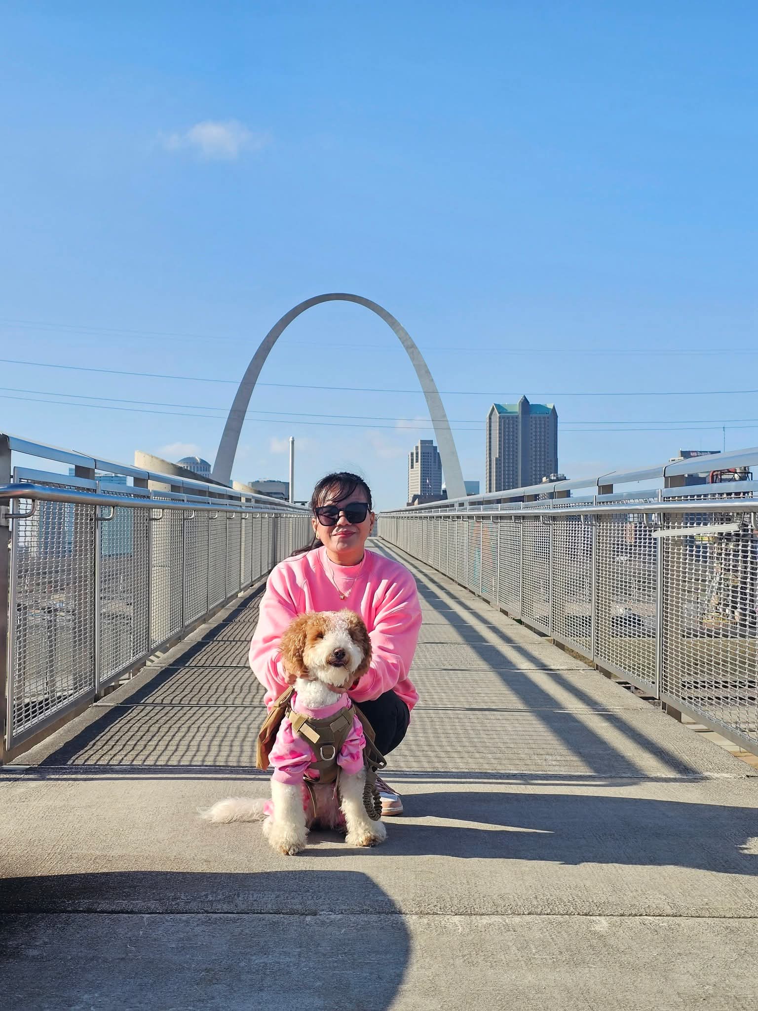 Luna and Mrs. Sparkle Cleaning Co. owner on a St. Louis bridge with the Gateway Arch